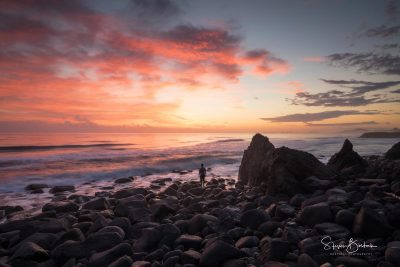 red sky rock silhouette man burleigh heads gold coast
