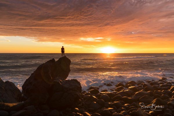 orange glow sunrise silhouette girl rocks burleigh heads gold coast